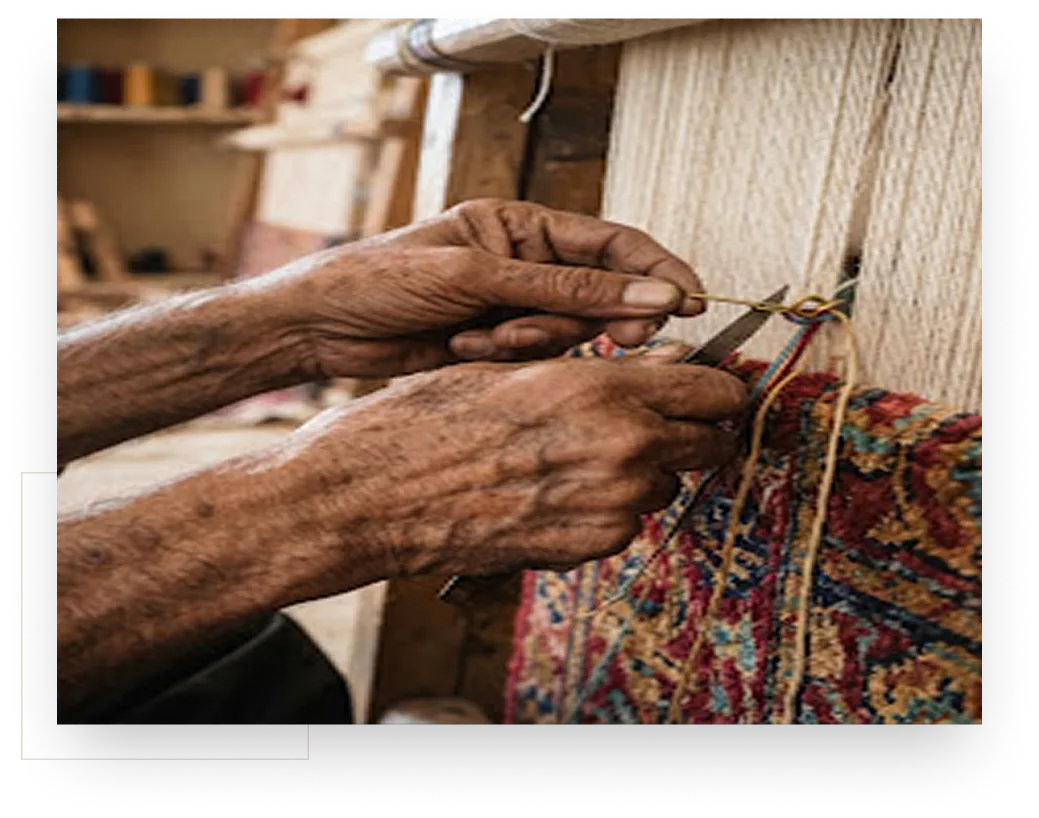 Artisan hands knotting a bespoke rug at the loom