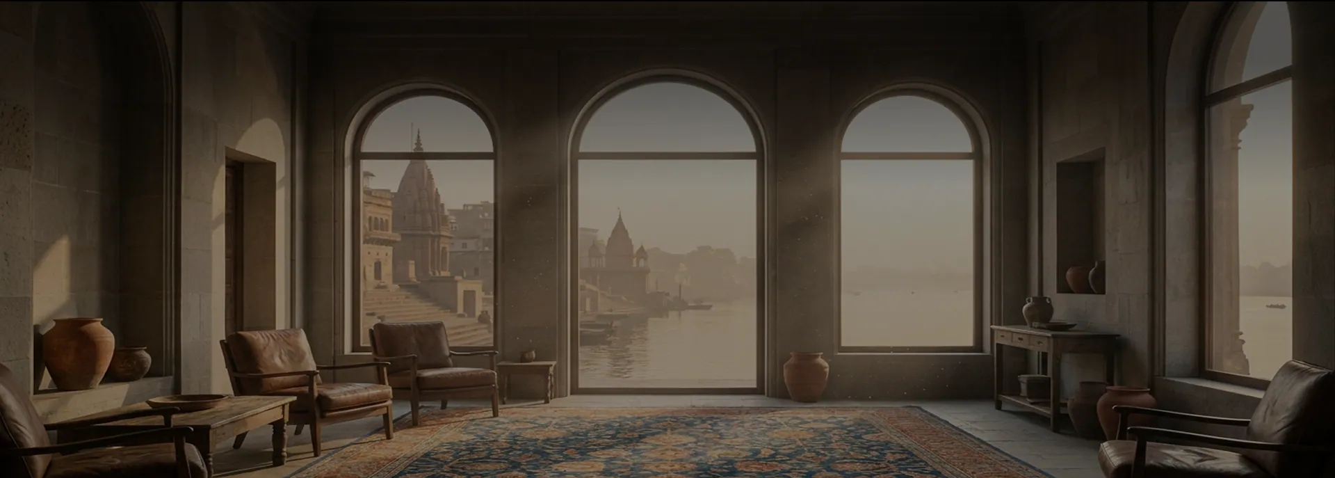 A serene atelier room overlooking the ghats with a handwoven rug laid across the floor